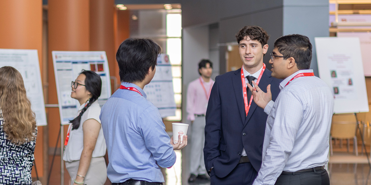 Students talking at poster fair